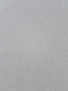 a bird is standing on the sand of the beach