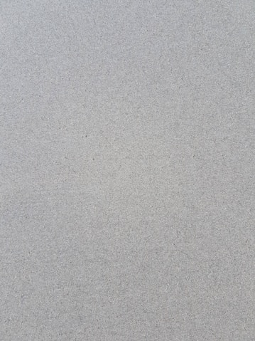 a bird is standing on the sand of the beach