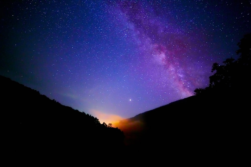 silhouette of mountain under nebula