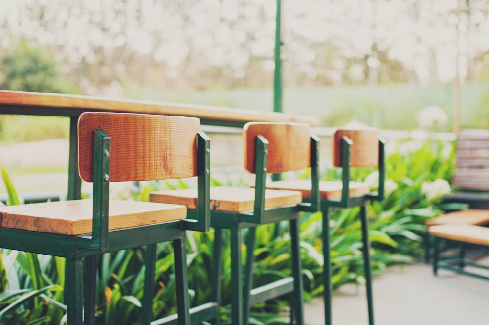 three bar stools under table\