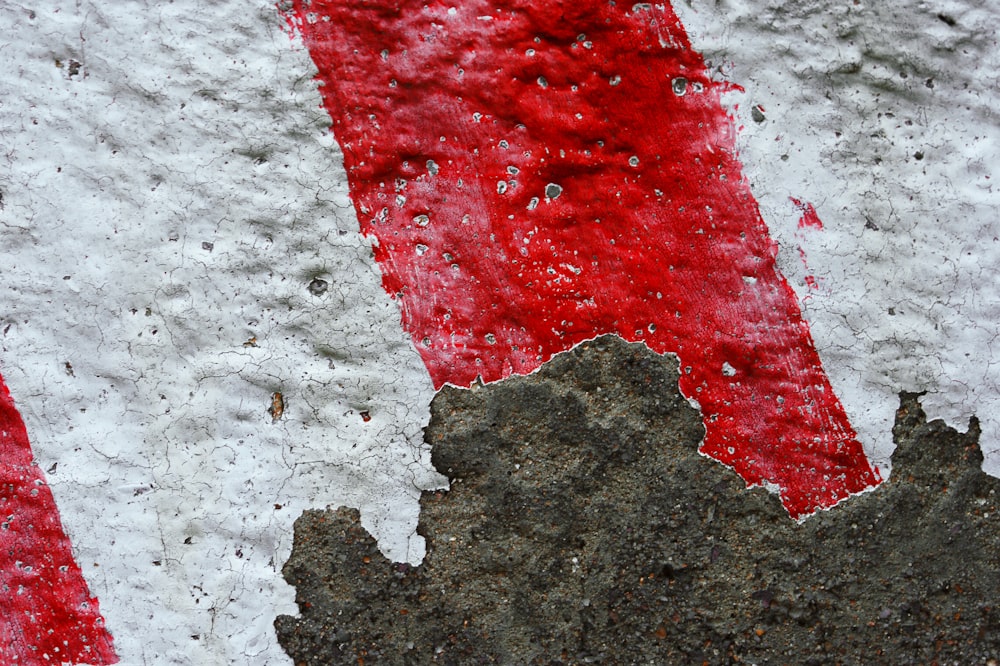 a close up of a red and white street sign