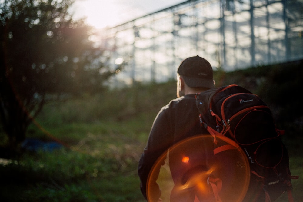 man carrying black and red backpack