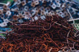 Various metal scraps including wires and rods in a container.