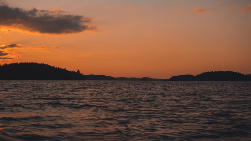 silhouette photography of hill during golden hour