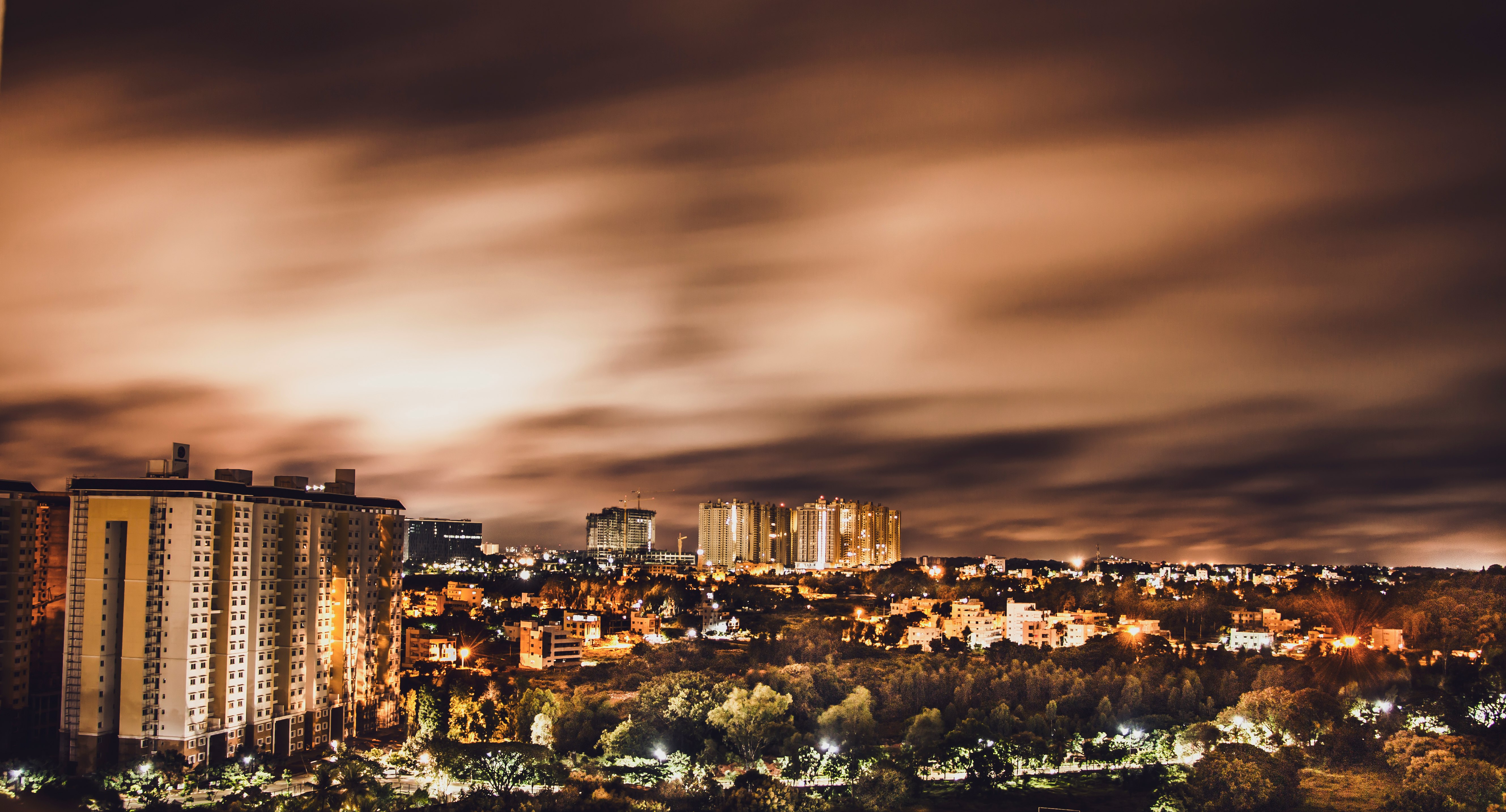 high rise buildings under brown sky