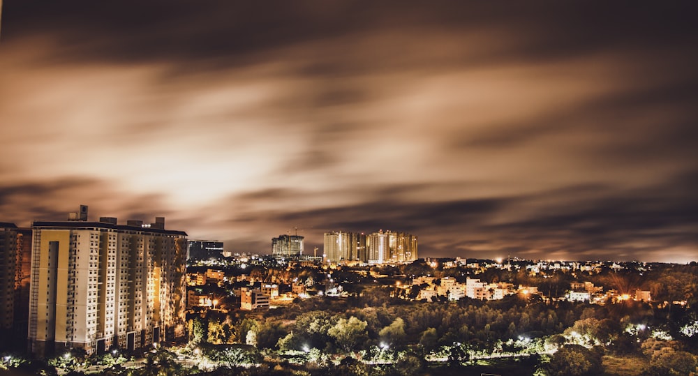 high rise buildings under brown sky