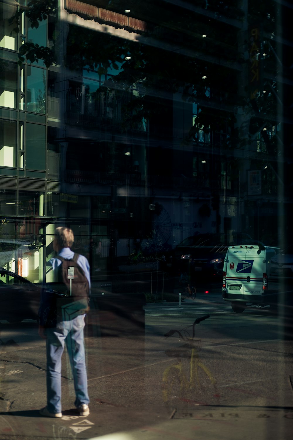 man crossing road in front of building