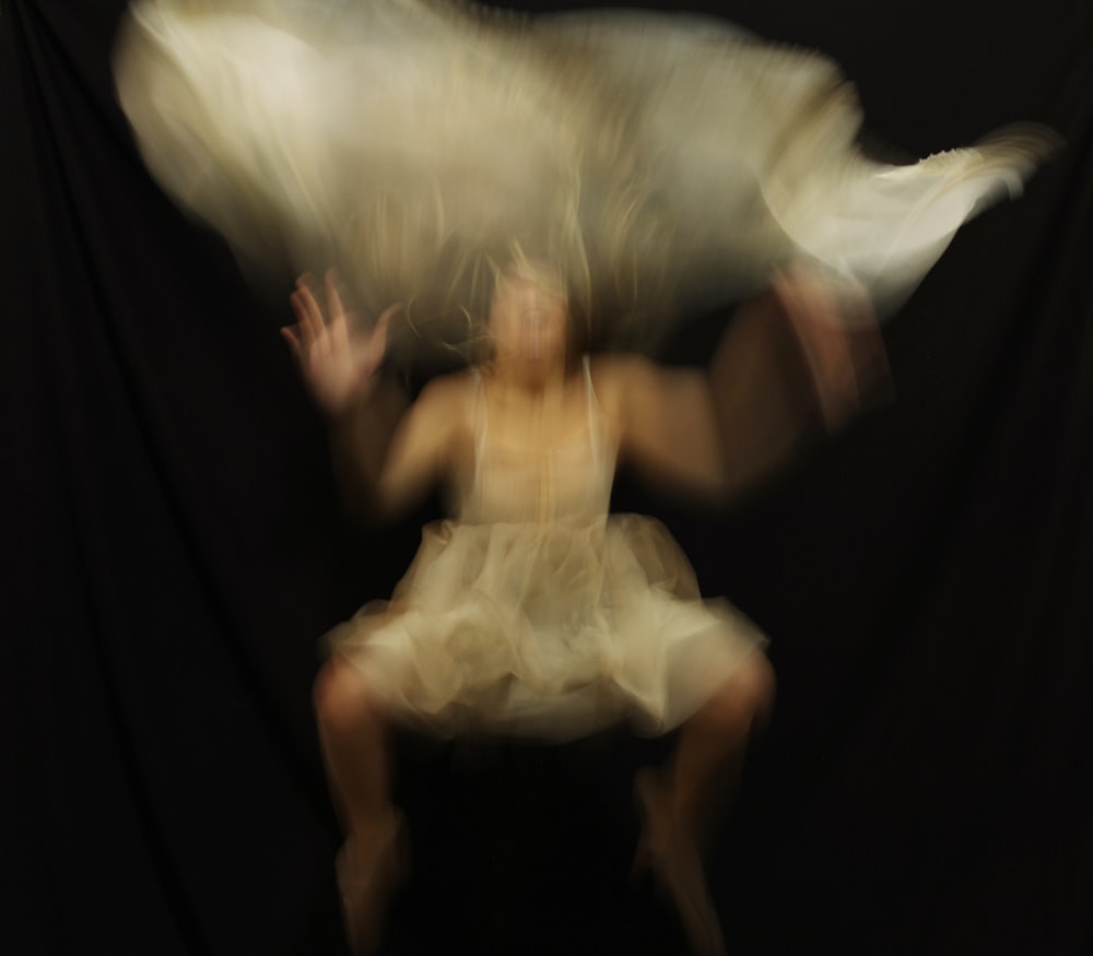 a blurry photo of a woman sitting on a chair