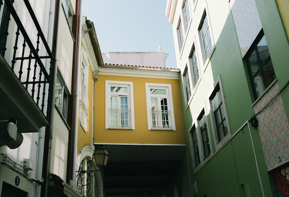 low angle photo of green and yellow concrete buildings