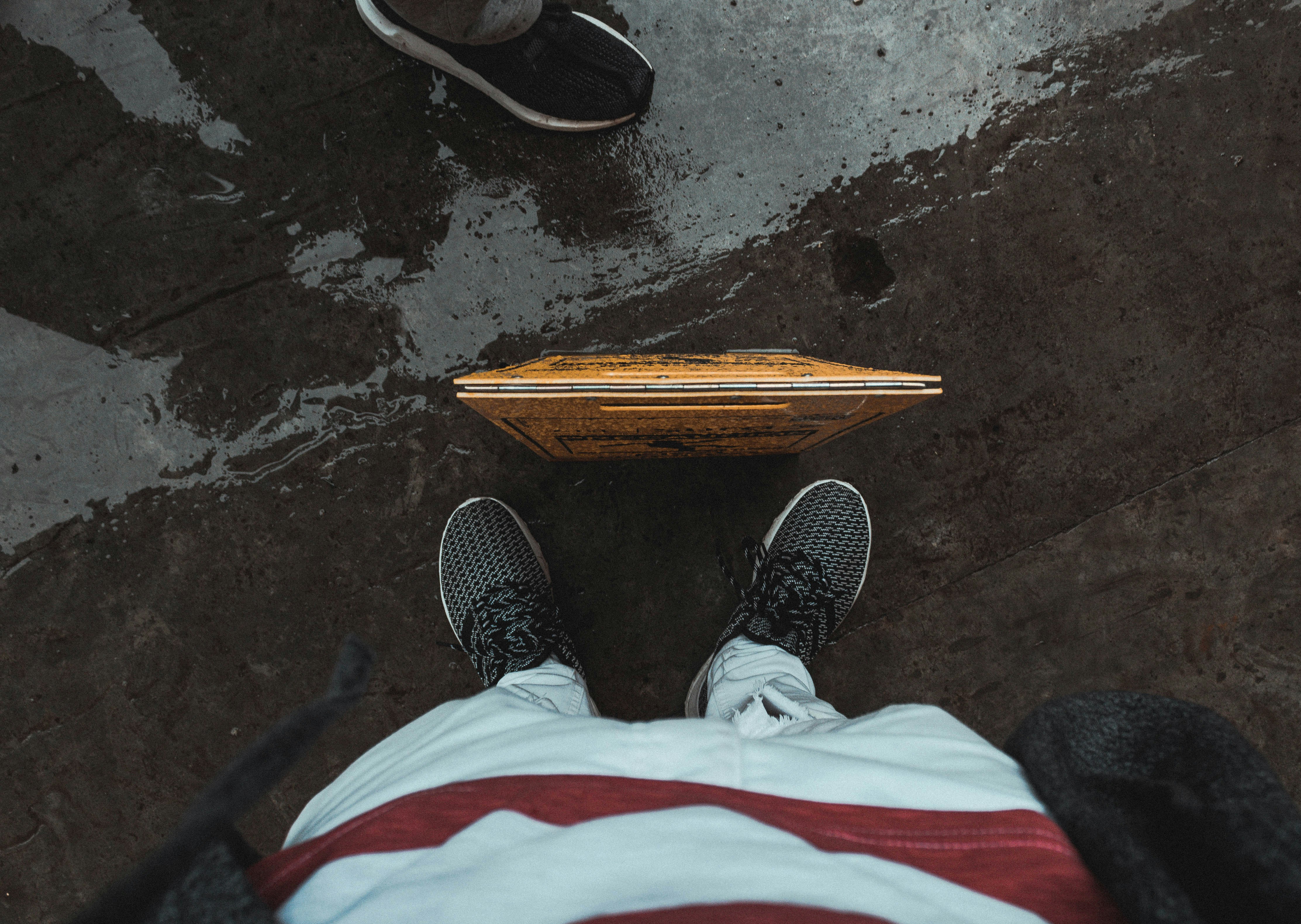 person wearing pair of black sneakerrs