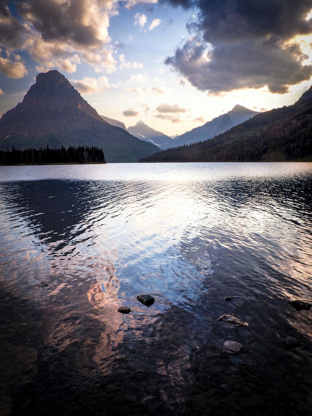 landscape photo of body of water surrounded by mountains