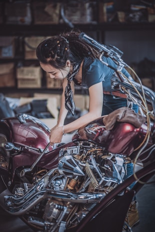 A skilled technician coding a motorcycle's electronic system in a modern workshop.