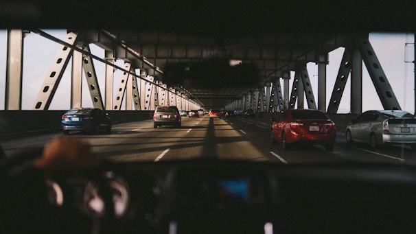 Wide-angle view of a newly constructed steel bridge spanning a river with vehicles crossing.