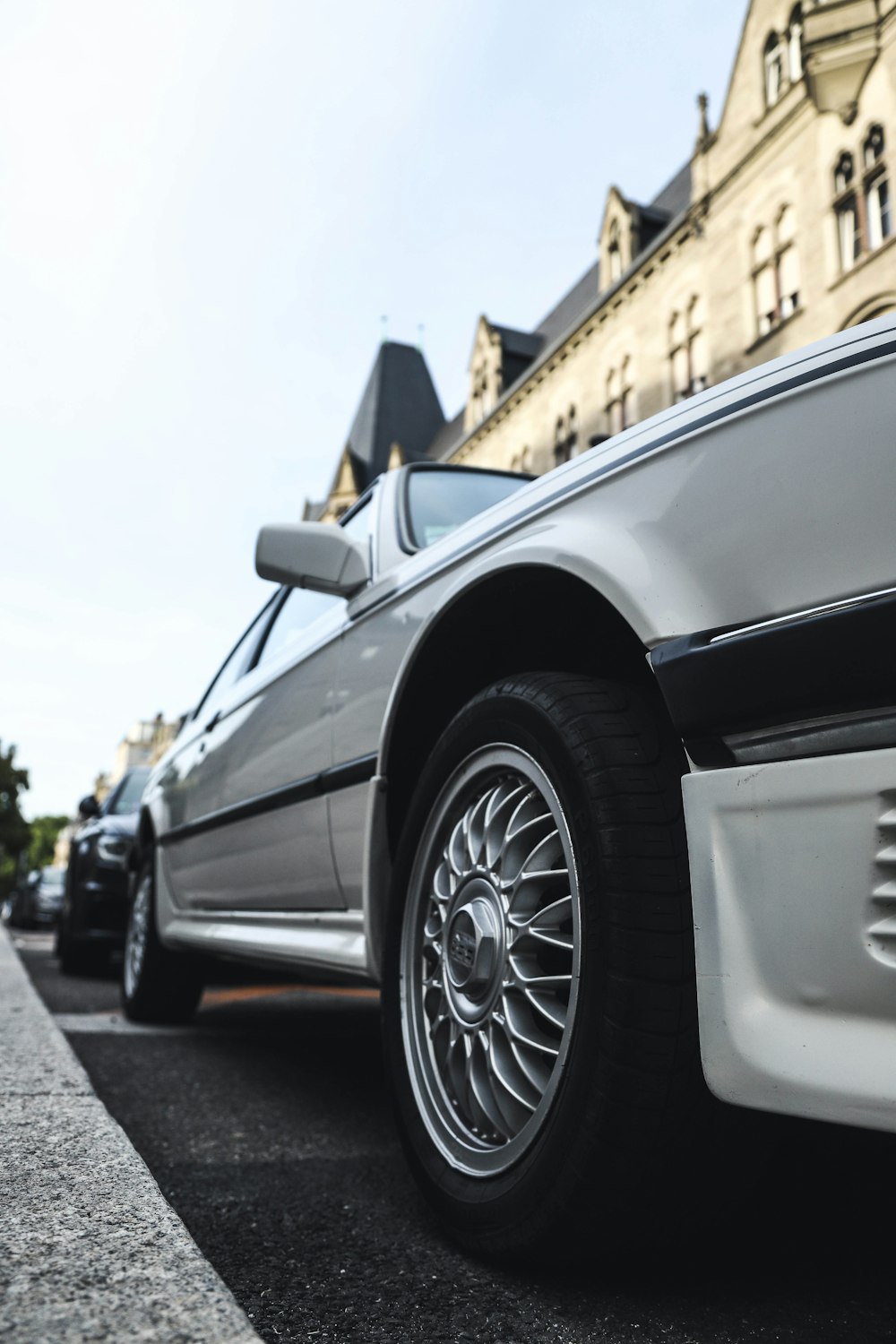 silver sedan parked near road curve