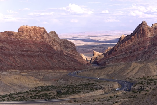 gray asphalt road between brown mountains during daytime in Utah United States