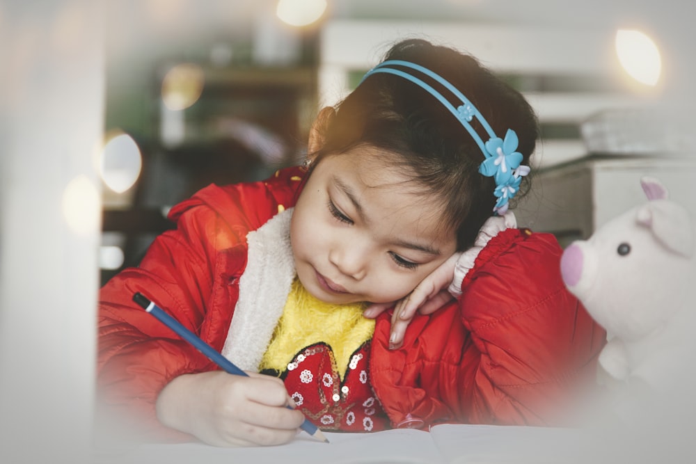 girl holding pencil