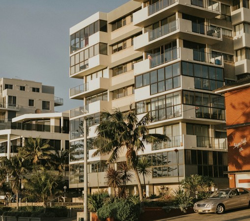 A Southwestern style apartment complex with palm trees and parked cars, typical of Clark County rental housing