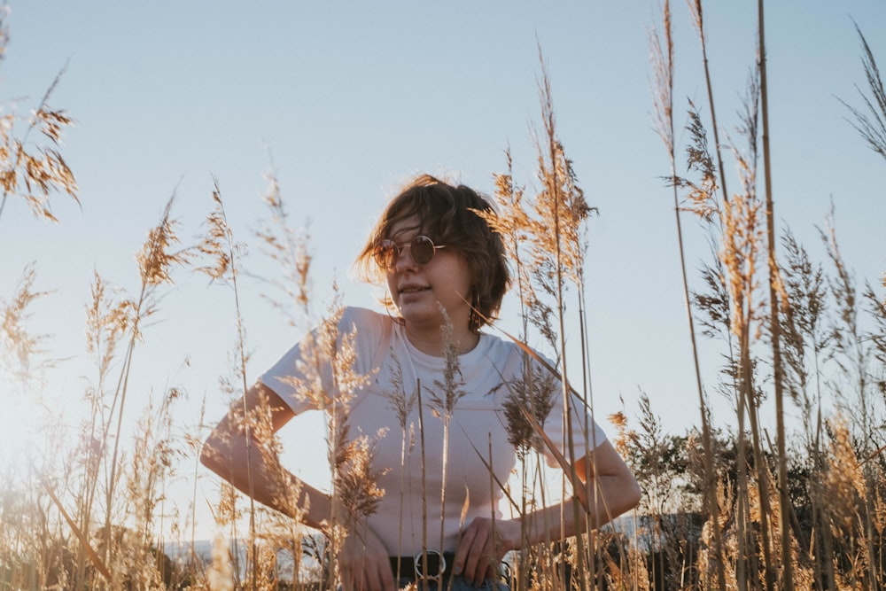 woman standing in front of brown grass