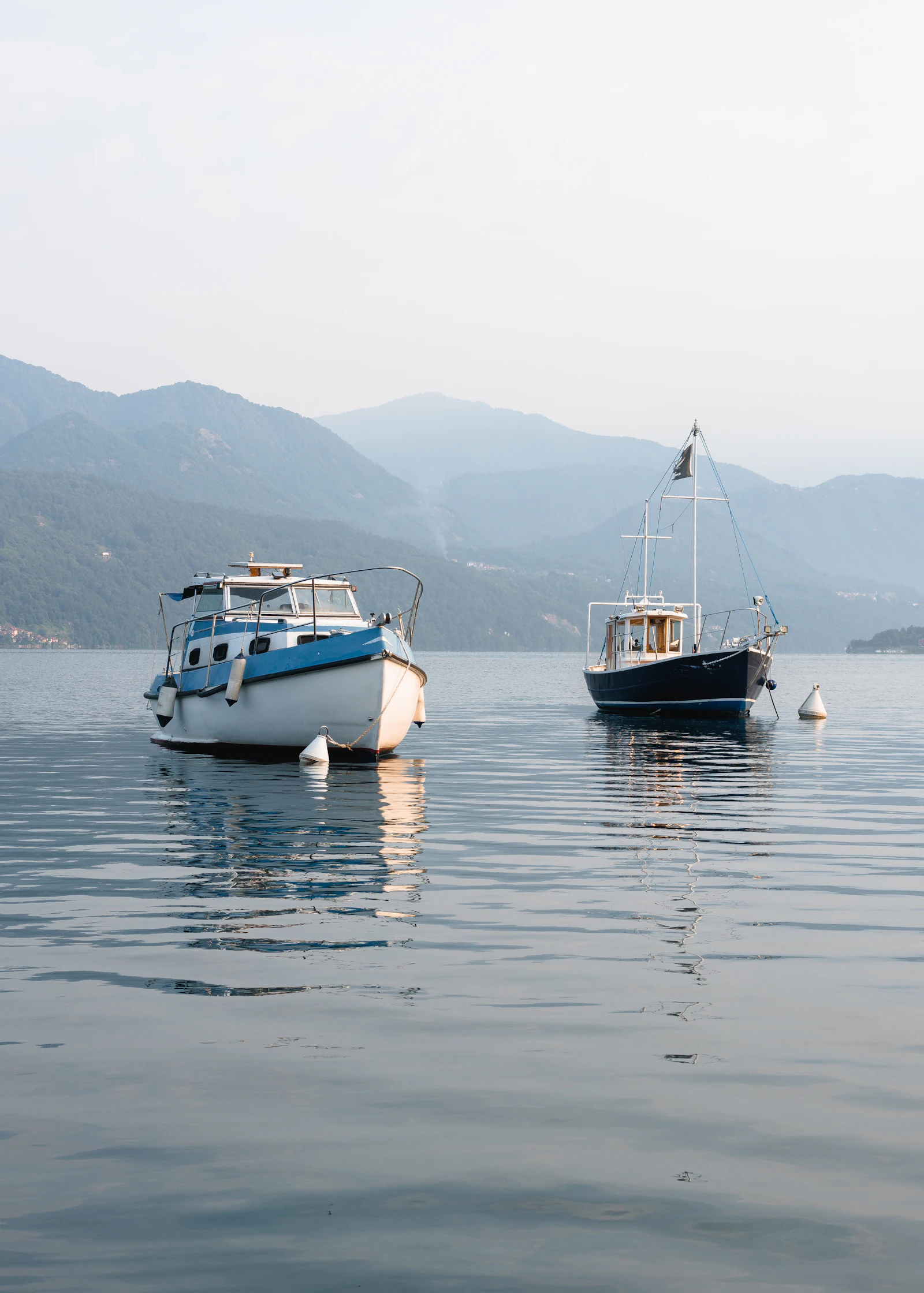 two motorboats moored on a calm lake