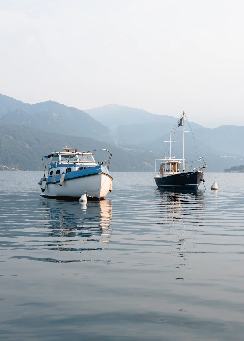 Two motorboats moored on a calm lake