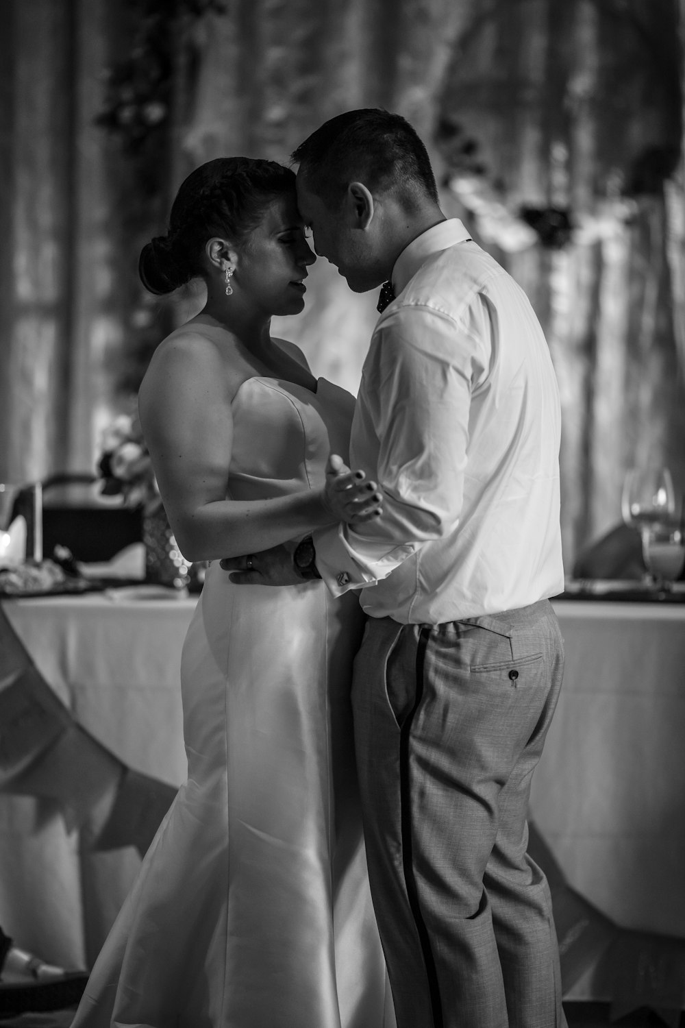 grayscale photography of man and woman facing each other