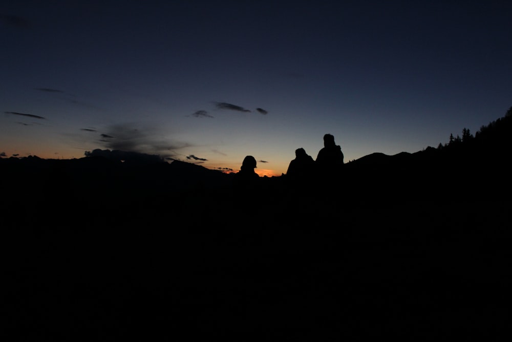 silhouette photography of three people