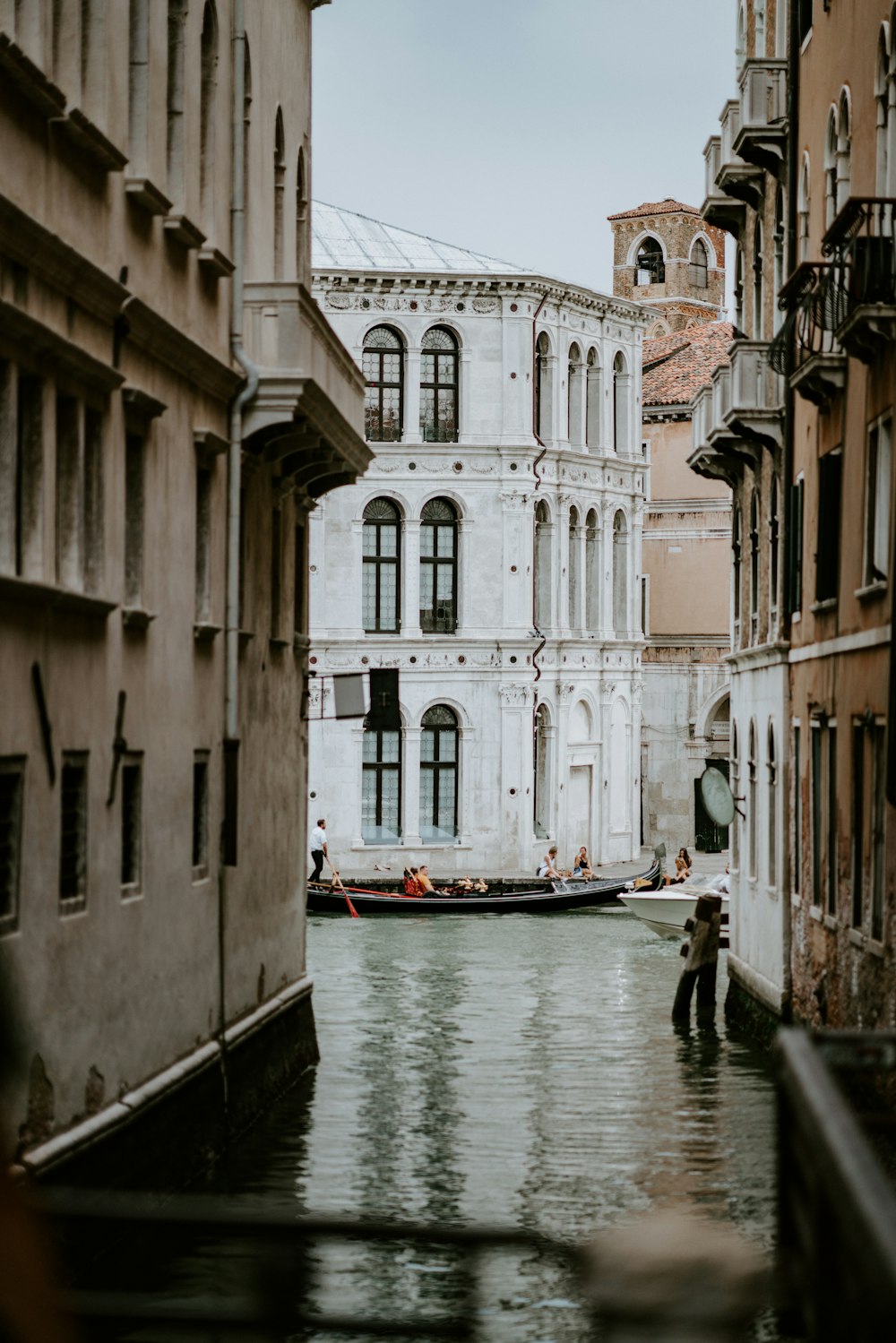 canal between beige and white concrete buildings at daytime