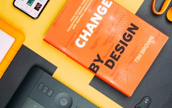 Change by Design by Tim Brown book beside smartphone