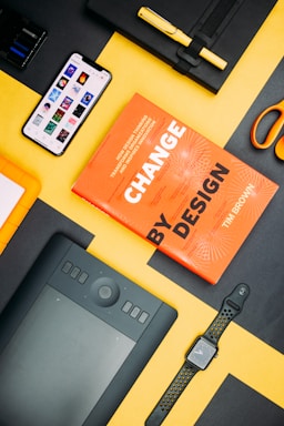 Change by Design by Tim Brown book beside smartphone