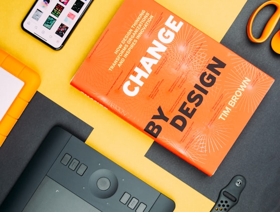 Change by Design by Tim Brown book beside smartphone