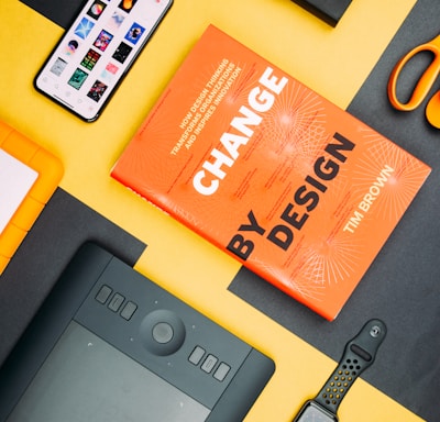 Change by Design by Tim Brown book beside smartphone