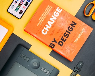 Change by Design by Tim Brown book beside smartphone