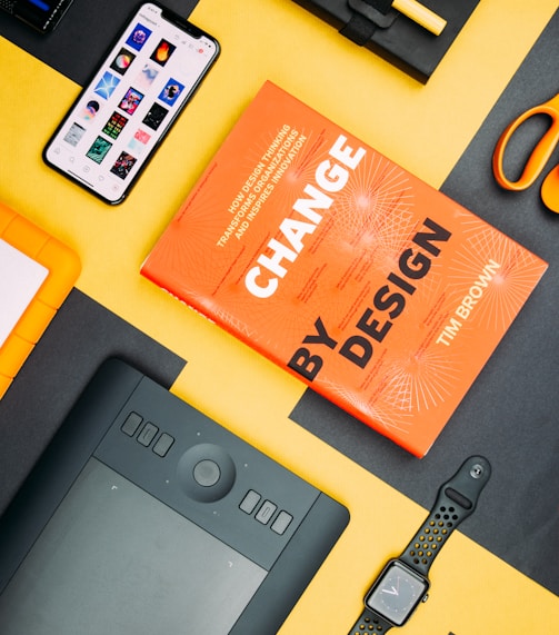 Change by Design by Tim Brown book beside smartphone