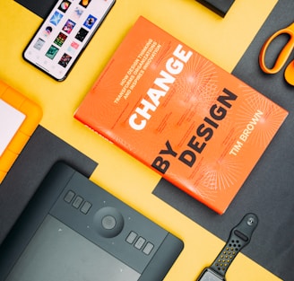 Change by Design by Tim Brown book beside smartphone