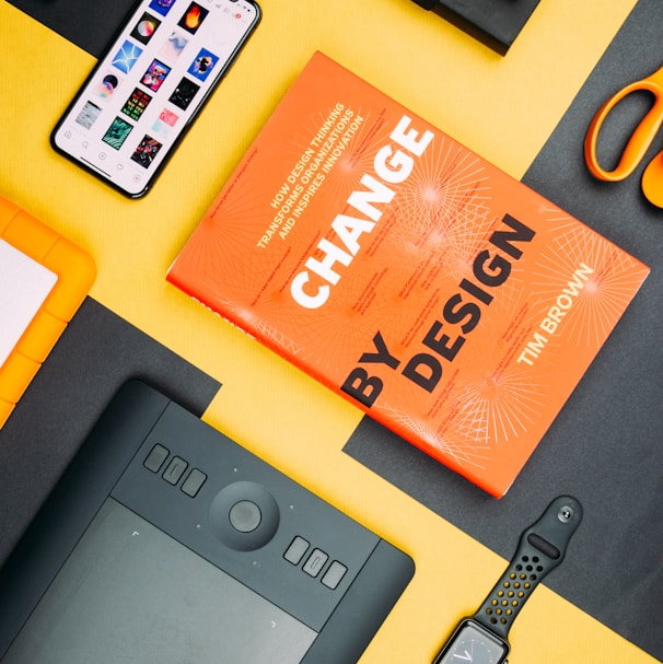 Change by Design by Tim Brown book beside smartphone