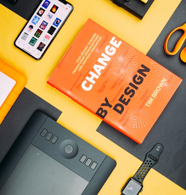 Change by Design by Tim Brown book beside smartphone