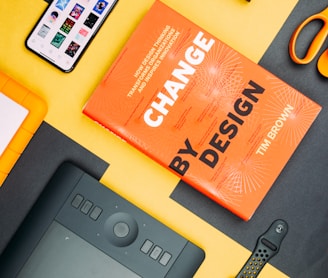 Change by Design by Tim Brown book beside smartphone