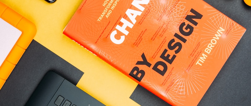 Change by Design by Tim Brown book beside smartphone