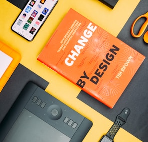 Change by Design by Tim Brown book beside smartphone