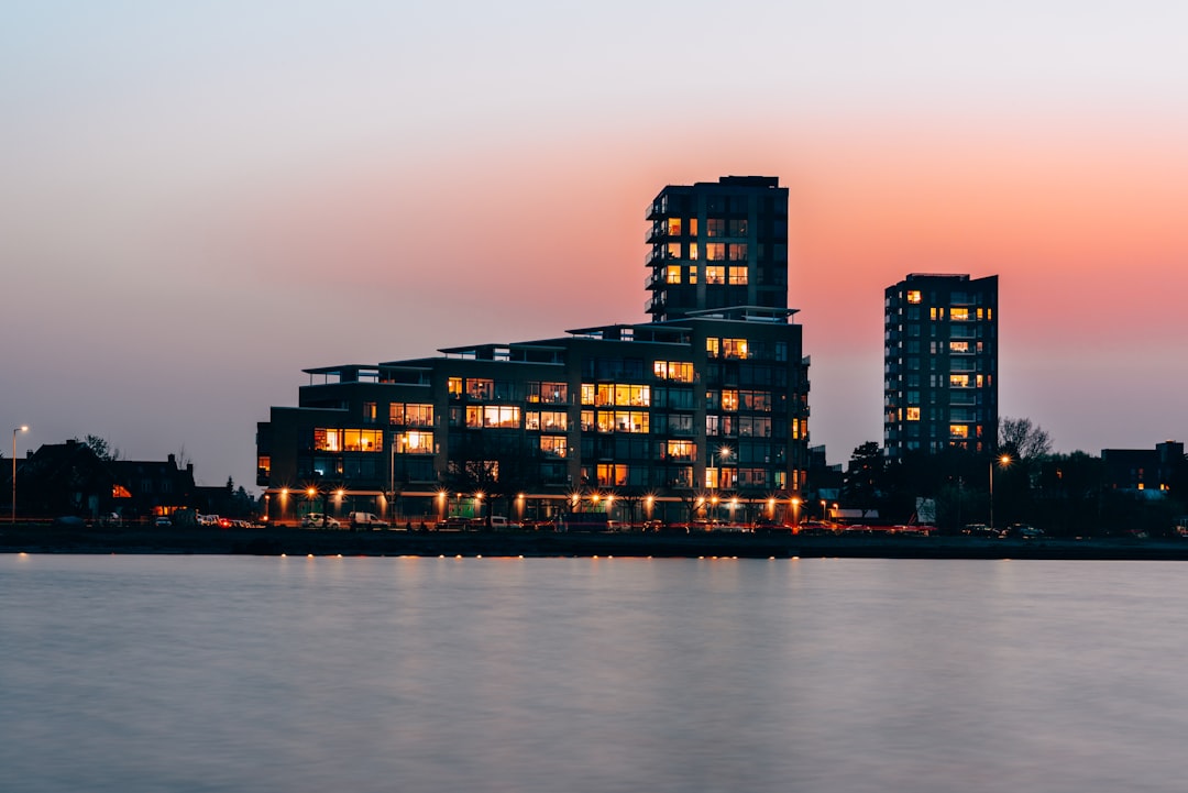 black building beside body of water,