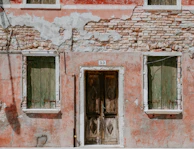 Exterior house facade showing weathered paint before renovation.