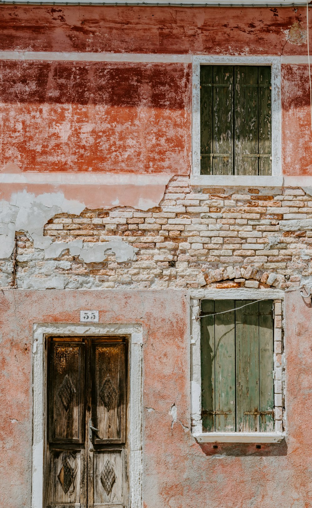 brown wooden door near gray wooden window