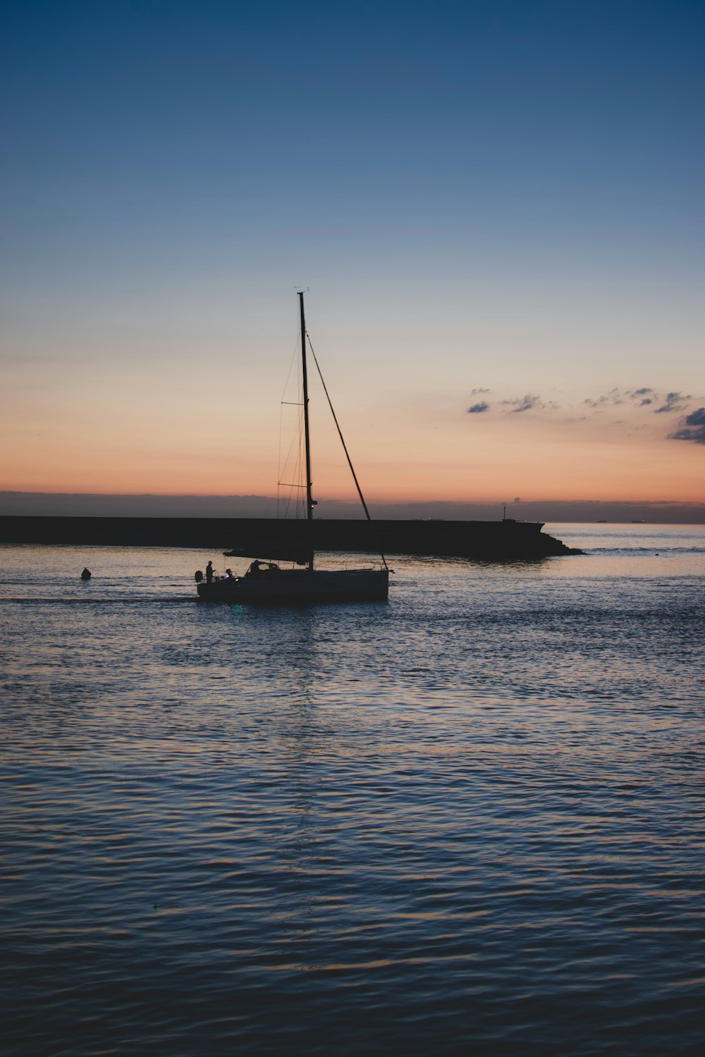 silhouette of sailboat during sunset