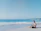 Happy man reviewing mortgage documents with a consultant by the sea