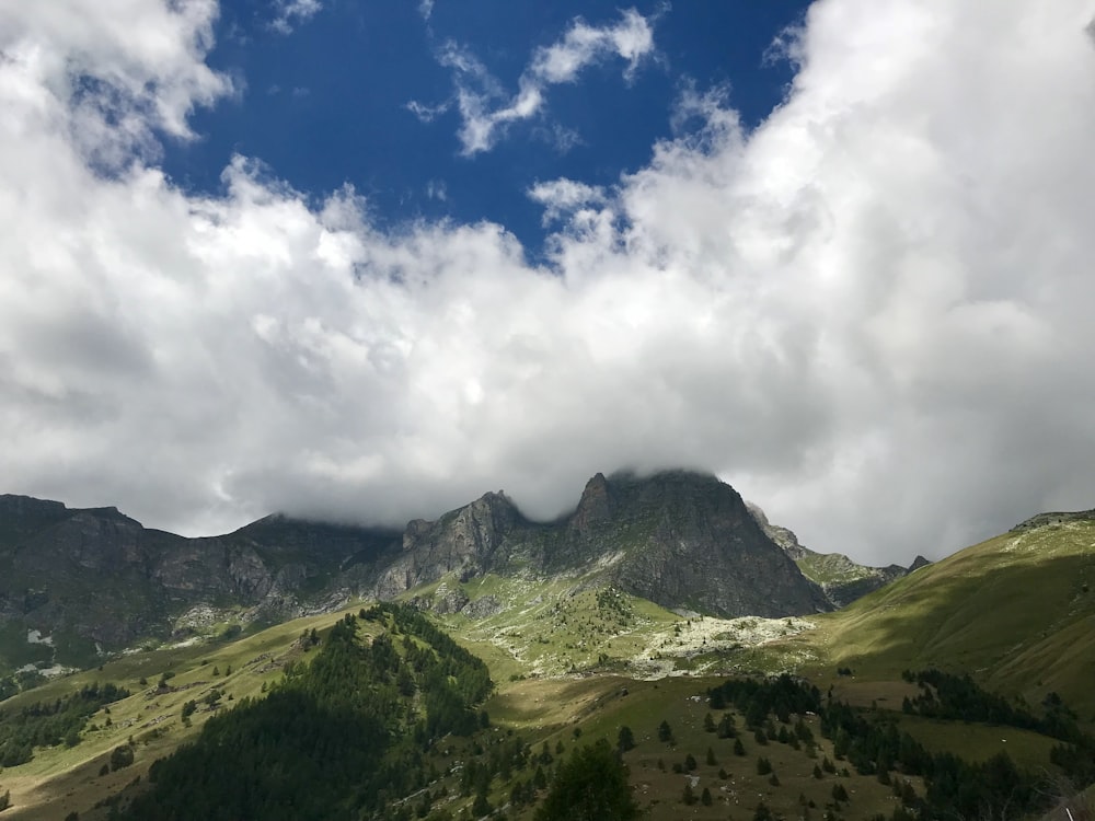 aerial photography of mountain under cloudy sky