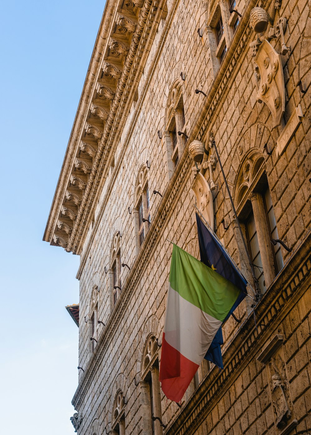 green red and yellow flag on brown concrete building