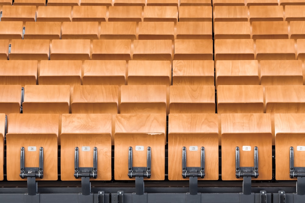rows of wooden seats in a large auditorium