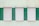 Three closed window shutters are aligned in a row on a textured wall. The wall is painted in alternating vertical green and light yellow stripes, creating a contrast between the white shutters and the background.