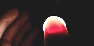 Close-up of a glowing ripple effect spreading from a fingertip on a dark interface.