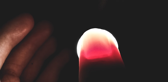 Close-up of the enlightenring on a forefinger, glowing softly against a serene background.